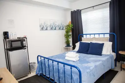 a bedroom with a blue bed with towels on it at Insta Worthy Oasis in Homestead