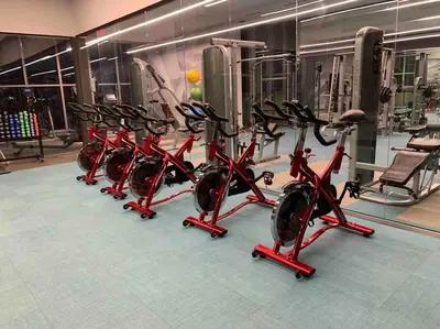 a row of red exercise bikes in a gym at Luxury Oceanview Studio at Miami Design District in Miami