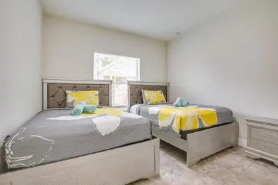 two twin beds in a room with a window at Stylish Fort Lauderdale Home 5 Mi to Beach! in Fort Lauderdale