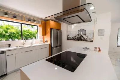 a kitchen with a sink and a refrigerator at Amazing Villa at Highland Lakes Boulevard BY THE GLAMHOMES in Miami