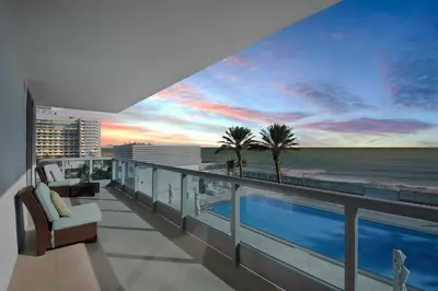 a balcony with a view of the beach and the ocean at Churchill Suites Monte Carlo Miami Beach in Miami Beach