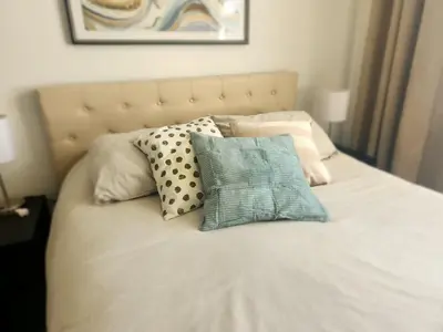 a bed with several pillows on top of it at Entire Beach Front Condo w/ pool Amazing view 4pax in Miami Beach
