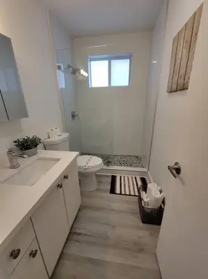 a white bathroom with a toilet and a shower at Sol Miami #1 with free parking on premises in Miami