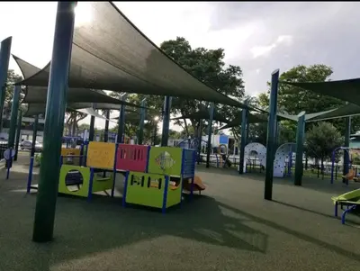a park with a playground with a canopy and benches at Sol Miami # 2 with free parking in Miami