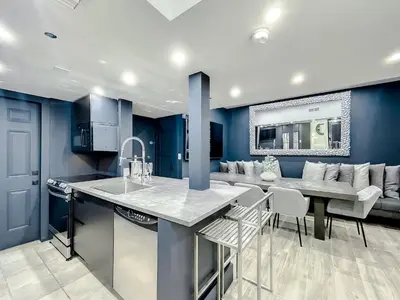 a kitchen with blue walls and a table and chairs at Oceanfront 3 Room Ocean Drive Condo in Miami Beach