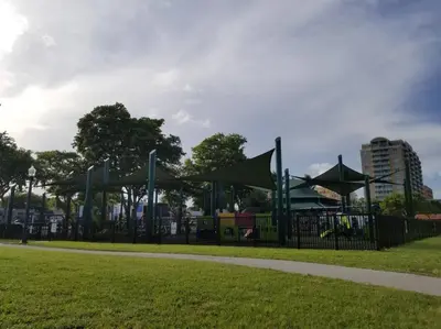 a playground in a park next to a grass field at My lovely home in Miami 15 minutes from the Beach in Miami