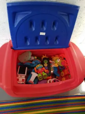 a red basket full of toys on a table at My lovely home in Miami 15 minutes from the Beach in Miami