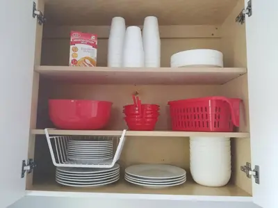 a cabinet filled with dishes and bowls and plates at My lovely home in Miami 15 minutes from the Beach in Miami
