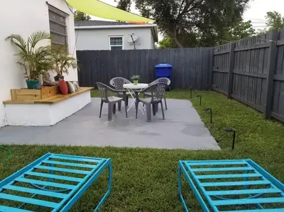 a backyard with a table and chairs and a fence at My lovely home in Miami 15 minutes from the Beach in Miami