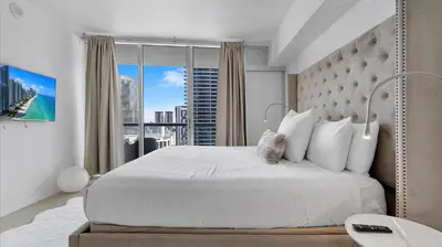 a bedroom with a large bed and a large window at Icon Brickell Stay, Pool, Spa, Views, Restaurants in Miami