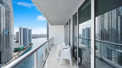 a balcony with a table and chairs on a building at Icon Brickell Stay, Pool, Spa, Views, Restaurants in Miami