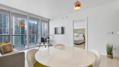 a white living room with a table and a couch at Icon Brickell Stay, Pool, Spa, Views, Restaurants in Miami