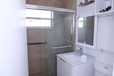 a bathroom with a toilet and a sink and a shower at Douglas rd apartments in Miami