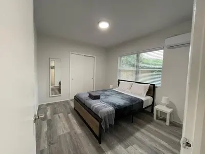 a bedroom with a bed and a window at Douglas rd apartments in Miami