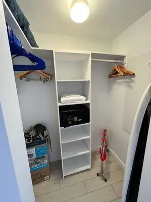 a room with a closet with shelves and a bed at Trendy Beachfront Flat, Sea Views, Style & Amenities -A in Hallandale Beach