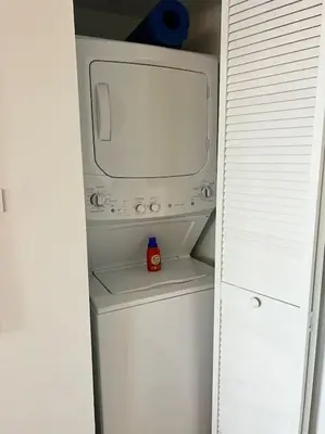 a small white refrigerator with a microwave in it at Trendy Beachfront Flat, Sea Views, Style & Amenities -A in Hallandale Beach