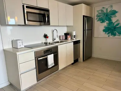 a kitchen with a sink and a stove top oven at Elegant Coastal Living, Full Kitchen & Panoramic Views -A in Hallandale Beach