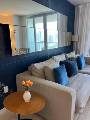 a living room with a couch and a table at Elegant Coastal Living, Full Kitchen & Panoramic Views -A in Hallandale Beach