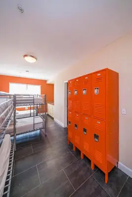 a room with two bunk beds and orange lockers at Beds n' Drinks in Miami Beach