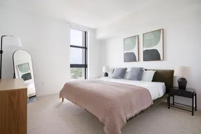 a white bedroom with a large bed and a mirror at Coral Gables 1br w pool wd nr shops airport MIA-74 in Miami