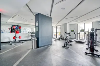 a gym with bikes and machines in a room at Coral Gables 1br w pool wd nr shops airport MIA-74 in Miami