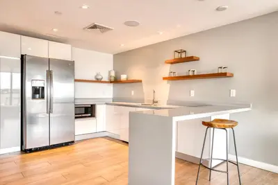 a kitchen with white cabinets and a stainless steel refrigerator at Coral Gables 1br w pool wd nr shops airport MIA-74 in Miami
