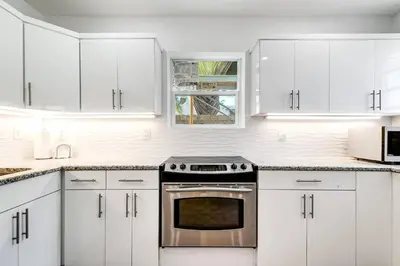 a white kitchen with white cabinets and an oven at Beautiful Shenandoah One Bedroom Fast Internet Shen3 in Miami