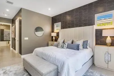 a bedroom with a large white bed with a bench at VILLA MAGNOLIA-with heated pool-by VIAC in Fort Lauderdale