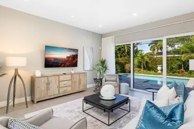 a living room with a couch and a table and a pool at VILLA MAGNOLIA-with heated pool-by VIAC in Fort Lauderdale