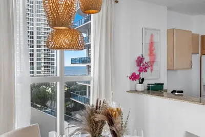 a kitchen with a large window with a view of the ocean at King David By The Ocean in Miami Beach