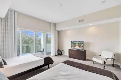 a bedroom with two beds and a balcony at Villa Vista-2 Story w 3Bdrms & Golf View in Miami