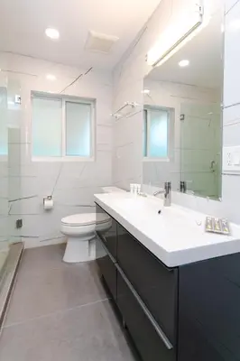 a white bathroom with a sink and a toilet at First-Class 5BR Villa in Hollywood Lakes in Hollywood