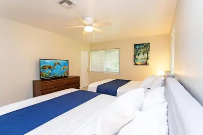 a bedroom with two beds and a ceiling fan at First-Class 5BR Villa in Hollywood Lakes in Hollywood