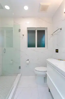 a white bathroom with a toilet and a glass shower at First-Class 5BR Villa in Hollywood Lakes in Hollywood