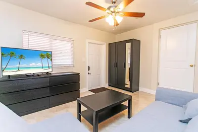 a living room with a tv and a couch at First-Class 5BR Villa in Hollywood Lakes in Hollywood