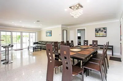 a dining room with a table and chairs at First-Class 5BR Villa in Hollywood Lakes in Hollywood