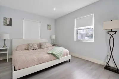 a white bedroom with a bed and a window at Massage Chair - Backyard - 5 min 2 DT Calle 8 Brickell in Miami
