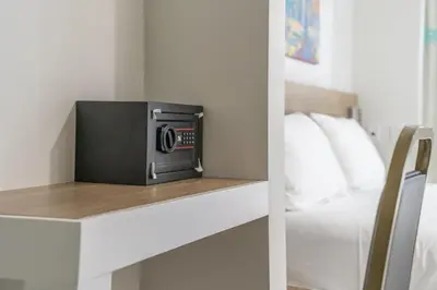 a microwave sitting on a shelf next to a bed at The Biscayne Hotel in Miami