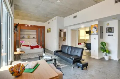 a living room with a couch and a bed at Trendy Downtown Miami Studio Pools, Views and More! in Miami