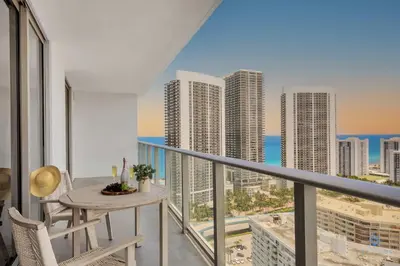 a balcony with a table and chairs and a view of the city at Awesome Bayview - Pools - Gym in Hollywood