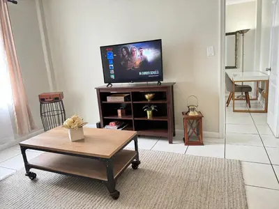 a living room with a tv and a coffee table at YOUR VACATION HOME! NEAR THE BEACH in Miami Beach