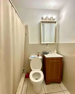 a bathroom with a toilet and a sink and a mirror at YOUR VACATION HOME! NEAR THE BEACH in Miami Beach