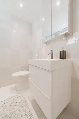 a white bathroom with a sink and a toilet at BEACH VIBES in Miami Beach
