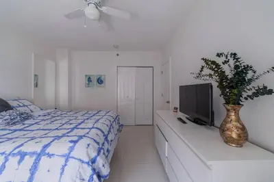 a bedroom with a bed and a tv on a dresser at OCEAN & SAND ONLY 1 MINUTE WALK! in Miami Beach