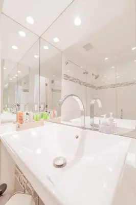 a bathroom with a sink and a large mirror at OCEAN & SAND ONLY 1 MINUTE WALK! in Miami Beach