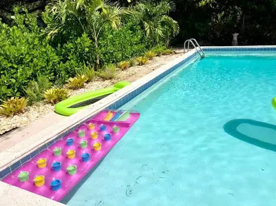 a pool with a bunch ofogie boards in a swimming pool at HOUSE WITH POOL, 10 MINS DRIVE TO THE BEACH! in Miami Shores
