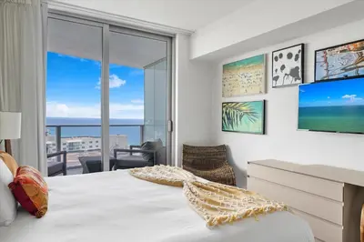 a bedroom with a bed and a view of the ocean at Stay on the beach-16th Floor Views Pool Gym in Hallandale Beach