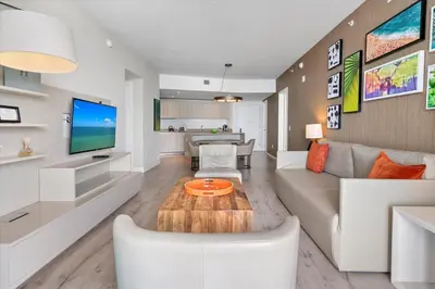 a living room with a couch and a table at Stay on the beach-16th Floor Views Pool Gym in Hallandale Beach