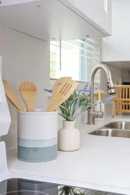 a kitchen counter with wooden spoons and spatulas at La Vie Boheme 1 - Relaxing Retreat w Parking in Miami