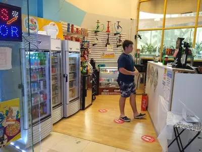 a man standing in front of a refrigerator in a store at Estudios para 4 personas en la playa de Sunny Isles Beach in Miami Beach